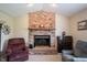 Close-up of living room brick fireplace with mantle and decor at 905 N Main St, Fortville, IN 46040
