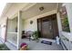 Charming front porch featuring a cozy bench and decorative plants, leading to the welcoming front door at 905 N Main St, Fortville, IN 46040