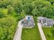 Aerial view of a property boasting a pool, patio, and lush landscaping, surrounded by mature trees at 9155 Kerwood Dr, Indianapolis, IN 46240
