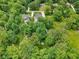 Expansive aerial view capturing lush greenery, mature trees, and multiple properties within a serene landscape at 9155 Kerwood Dr, Indianapolis, IN 46240