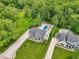 Aerial view showcasing the property's backyard oasis with a pool, patio, and beautiful landscaping at 9155 Kerwood Dr, Indianapolis, IN 46240