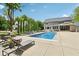 Spacious backyard with a large pool, outdoor seating, a dining area, and landscaped features, perfect for entertaining at 9155 Kerwood Dr, Indianapolis, IN 46240