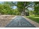 Entertain in style with a shuffleboard, lush lawn, and a charming shed creating a perfect outdoor escape at 9155 Kerwood Dr, Indianapolis, IN 46240