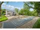 This backyard boasts a shuffleboard, deck with lounge seating, and a picturesque view of the home at 9155 Kerwood Dr, Indianapolis, IN 46240