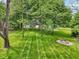 Expansive backyard with manicured lawn and a fire pit, perfect for outdoor enjoyment and entertainment at 9155 Kerwood Dr, Indianapolis, IN 46240