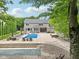 Stunning backyard oasis featuring a sparkling pool, patio, lounge seating, and manicured landscaping at 9155 Kerwood Dr, Indianapolis, IN 46240