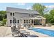 Spacious backyard with outdoor seating, lounge chairs, and a swimming pool, perfect for relaxation and entertainment at 9155 Kerwood Dr, Indianapolis, IN 46240