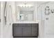 Bathroom featuring a gray vanity, a large mirror, and a glass-enclosed shower with white tile at 9155 Kerwood Dr, Indianapolis, IN 46240