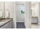 Spacious bathroom featuring double granite vanities and an adjacent walk-in closet at 9155 Kerwood Dr, Indianapolis, IN 46240