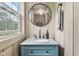 This bathroom boasts a modern vanity with granite countertops, a stylish round mirror, and sleek fixtures for a touch of elegance at 9155 Kerwood Dr, Indianapolis, IN 46240