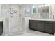 Primary bathroom showcasing a double vanity, walk-in shower, and a view from the window at 9155 Kerwood Dr, Indianapolis, IN 46240