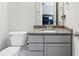 Bathroom with gray vanity, granite countertop, and view into the bedroom at 9155 Kerwood Dr, Indianapolis, IN 46240