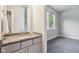 Elegant bathroom with granite vanity and a large window for natural light; view into bedroom at 9155 Kerwood Dr, Indianapolis, IN 46240