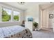 Bright bedroom with a patterned duvet, large windows, and a white dresser with tv on top at 9155 Kerwood Dr, Indianapolis, IN 46240