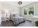 Cozy bedroom with a large window, gray walls, a patterned duvet and carpeted floors at 9155 Kerwood Dr, Indianapolis, IN 46240