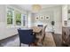 Elegant dining room with a chandelier, large windows, and ample seating for Gathering and guests at 9155 Kerwood Dr, Indianapolis, IN 46240