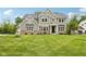 Charming two-story home with a lush green lawn and attractive landscaping in a desirable neighborhood at 9155 Kerwood Dr, Indianapolis, IN 46240