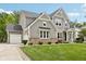Charming home exterior with stone accents, a well-kept lawn, and a welcoming entrance at 9155 Kerwood Dr, Indianapolis, IN 46240