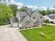 Beautifully designed exterior with a well-manicured lawn, complementing the home's architectural details at 9155 Kerwood Dr, Indianapolis, IN 46240