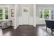 Inviting foyer featuring dark wood floors, natural light, and a view to other living spaces at 9155 Kerwood Dr, Indianapolis, IN 46240