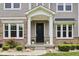 Close up of the covered front porch featuring stone pillars and decorative plants at 9155 Kerwood Dr, Indianapolis, IN 46240