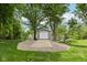 View of the spacious garage with a single-car door, set amidst a lush yard with trees, adding convenience and charm at 9155 Kerwood Dr, Indianapolis, IN 46240