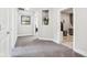Hallway with neutral colored walls, carpet, recessed art niche and views to other rooms at 9155 Kerwood Dr, Indianapolis, IN 46240