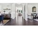 Open hallway featuring dark wood floors, neutral walls, and views to other rooms in the house at 9155 Kerwood Dr, Indianapolis, IN 46240