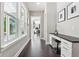 Hallway with hardwood floors featuring a built-in desk and natural light from windows at 9155 Kerwood Dr, Indianapolis, IN 46240