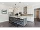 Modern kitchen with white cabinets, stainless steel appliances, and a gray island with bar seating at 9155 Kerwood Dr, Indianapolis, IN 46240