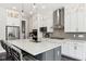 Bright kitchen features white cabinets, stainless appliances, gray backsplash, and large island with seating at 9155 Kerwood Dr, Indianapolis, IN 46240