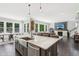Kitchen island with stainless farmhouse sink is part of a large open floor plan with dining and living areas at 9155 Kerwood Dr, Indianapolis, IN 46240
