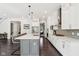 Spacious open kitchen with white cabinetry, stainless steel appliances and large center island with seating at 9155 Kerwood Dr, Indianapolis, IN 46240