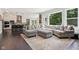 Open-concept living area featuring modern furnishings flowing from kitchen and dining areas at 9155 Kerwood Dr, Indianapolis, IN 46240