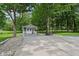 Cozy backyard shed features a covered porch, creating a charming retreat surrounded by lush greenery and a peaceful atmosphere at 9155 Kerwood Dr, Indianapolis, IN 46240