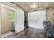 The well-lit shed interior has a garage door, a side entry, and ample storage, offering versatility and functionality at 9155 Kerwood Dr, Indianapolis, IN 46240