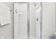 Bright shower with white subway tiles, a glass door, and chrome fixtures at 9155 Kerwood Dr, Indianapolis, IN 46240