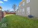 Spacious backyard with a well-maintained lawn and a wooden privacy fence providing a secure outdoor space at 921 S State Ave, Indianapolis, IN 46203
