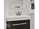 Close-up of a modern bathroom vanity with a black cabinet and a stylish sink at 921 S State Ave, Indianapolis, IN 46203