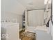 Neutral bathroom with vanity and shower, featuring a washer and dryer for added convenience at 921 S State Ave, Indianapolis, IN 46203