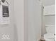 A clean and bright bathroom featuring a shower with a curtain, a toilet, and a towel rack at 921 S State Ave, Indianapolis, IN 46203