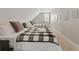 Comfortable bedroom featuring two twin beds, neutral walls, and plush carpeting with stylish black and white patterned throws at 921 S State Ave, Indianapolis, IN 46203