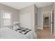 Well-lit bedroom featuring plush carpeting, a closet, and a comfortable bed with stylish blanket at 921 S State Ave, Indianapolis, IN 46203