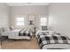 Comfortable bedroom featuring two twin beds with neutral walls, decorative wall art and natural light from the windows at 921 S State Ave, Indianapolis, IN 46203