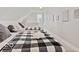 Charming bedroom featuring two beds with black and white checkered comforters and neutral decor at 921 S State Ave, Indianapolis, IN 46203