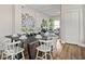 Charming dining room featuring a dark wood table, seating for eight, and a view into the living room at 921 S State Ave, Indianapolis, IN 46203