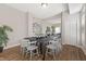 Bright dining area that opens into the living room, features dark wood table and seating for eight at 921 S State Ave, Indianapolis, IN 46203