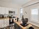 The well-lit kitchen has an island, stainless steel appliances, and wood countertops at 921 S State Ave, Indianapolis, IN 46203