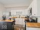 Bright kitchen boasts stainless steel appliances, white cabinets, wood countertops, and a decorative chicken at 921 S State Ave, Indianapolis, IN 46203