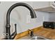 Updated kitchen featuring stainless steel appliances, white cabinets, wood countertops, and a black kitchen island at 921 S State Ave, Indianapolis, IN 46203